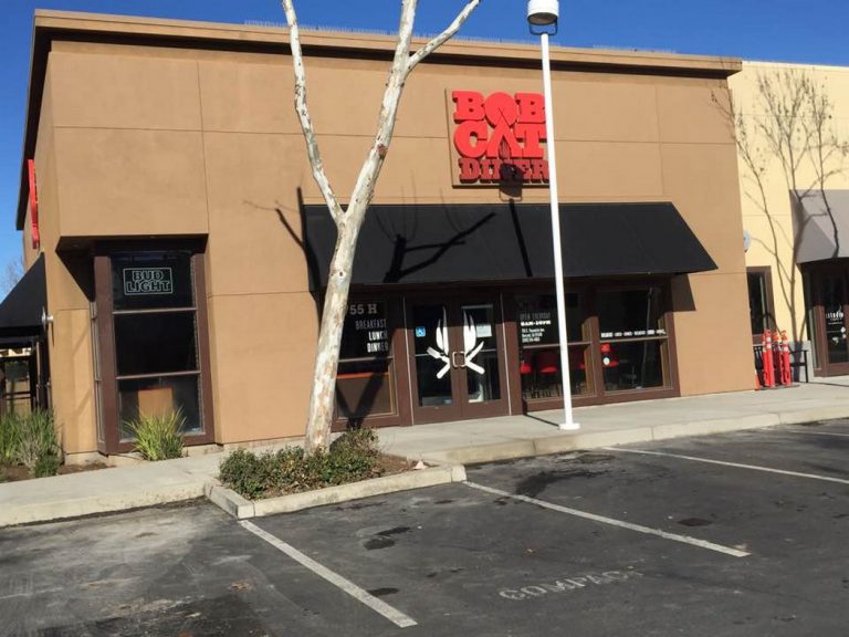 The front of a business with a black awning.