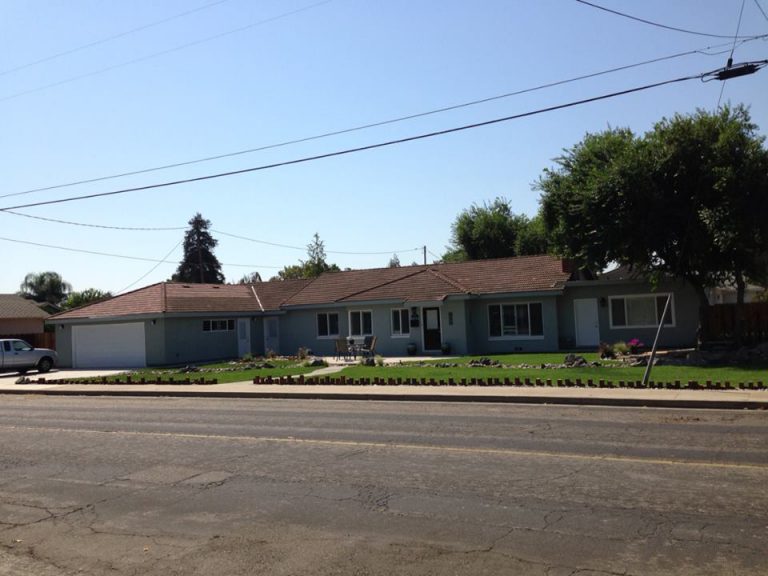 A house with a car parked in front of it.