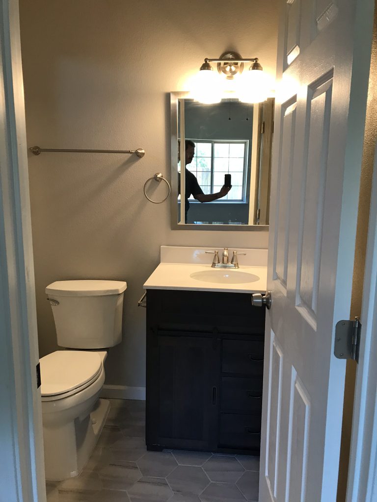 A bathroom with a toilet and sink.