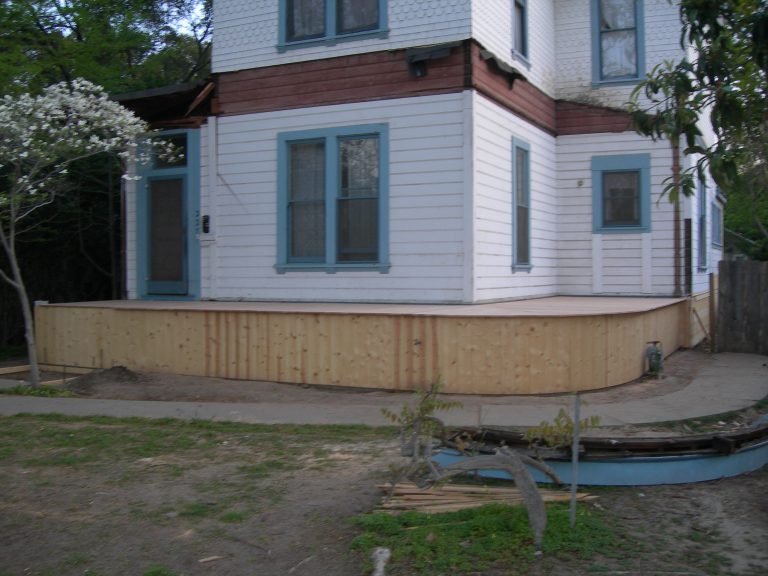A white house with blue trim.