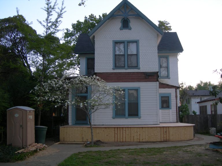 A white house with a blue roof.