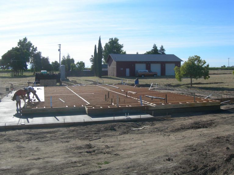 A man is working on a foundation for a house.