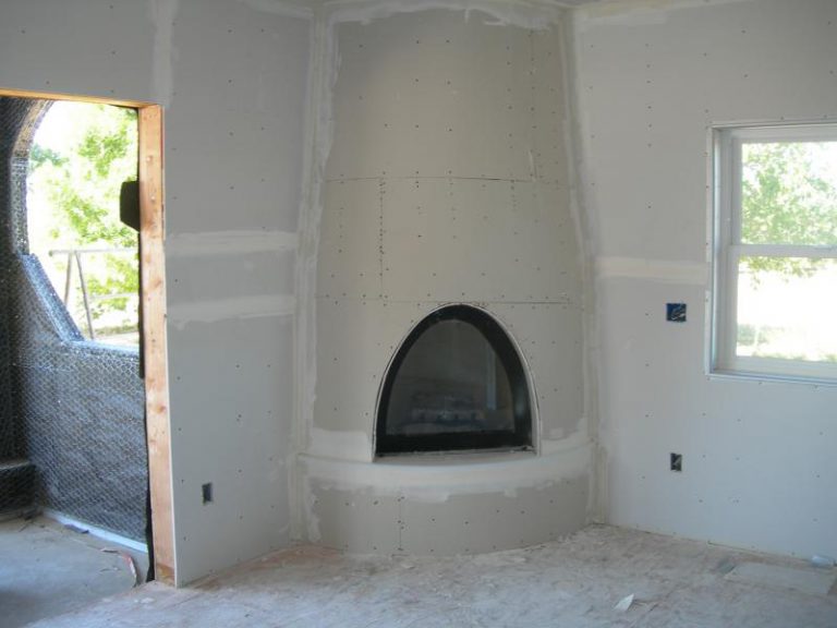 A room is being remodeled with a fireplace.