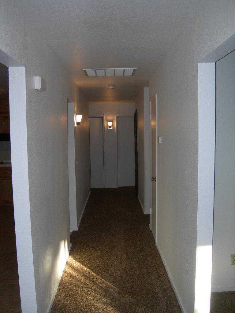 A hallway with a light shining down on it.