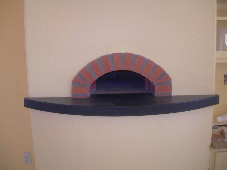 A brick oven in a kitchen with a brick wall.