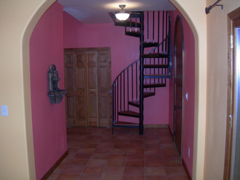 A spiral staircase in a hallway.