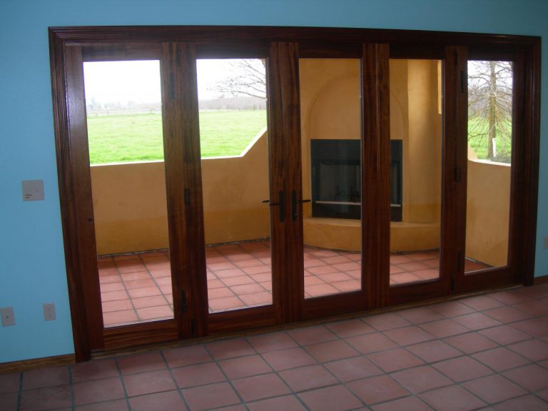 A sliding glass door in a room with a fireplace.