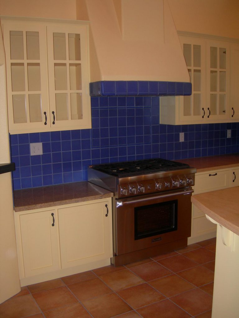 A blue tiled kitchen.
