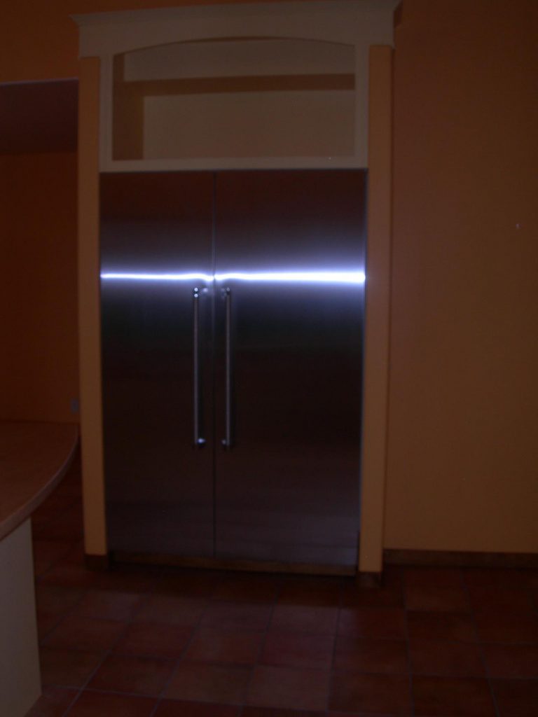 A stainless steel refrigerator in a kitchen.