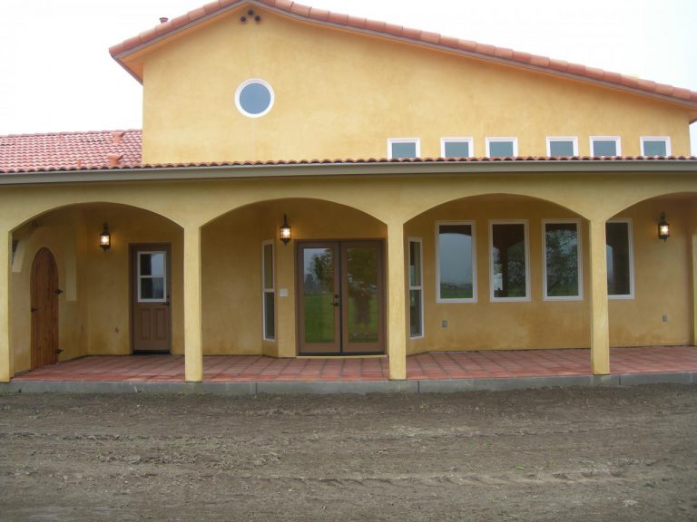 A yellow house with an arched doorway.