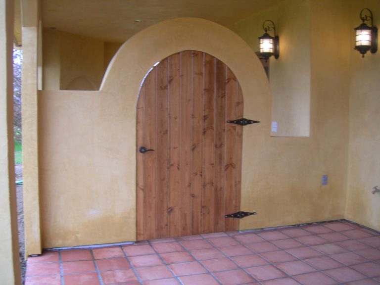 A wooden door on a tiled floor.