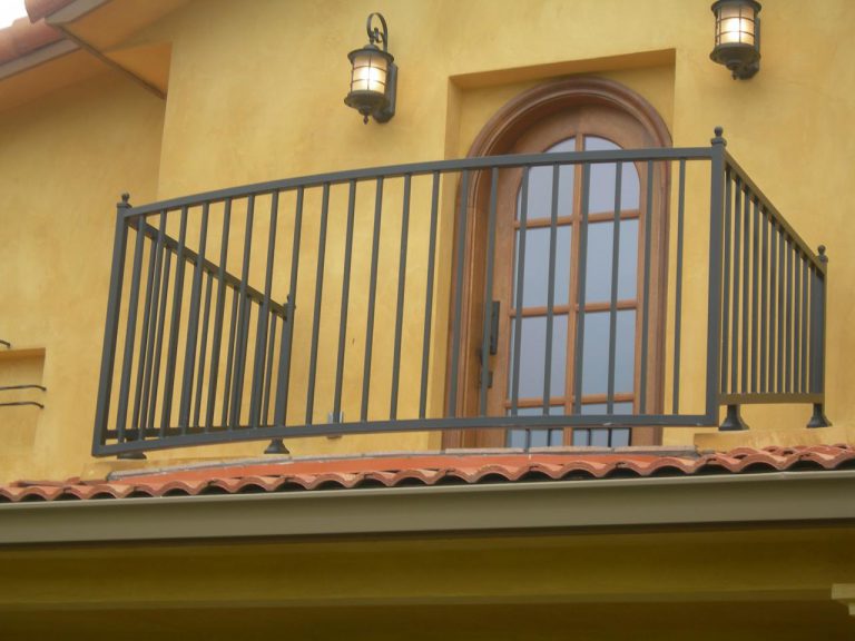 A black wrought iron railing on a balcony.