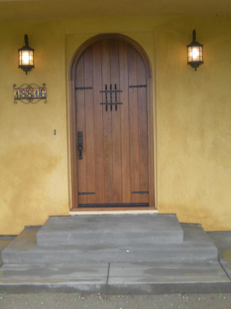 A wooden door with a light on it.