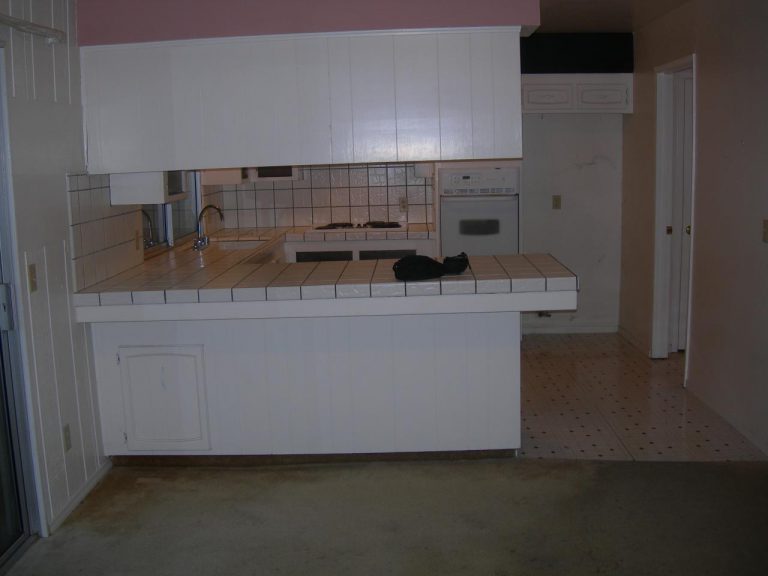 A kitchen with a sink and counter tops.