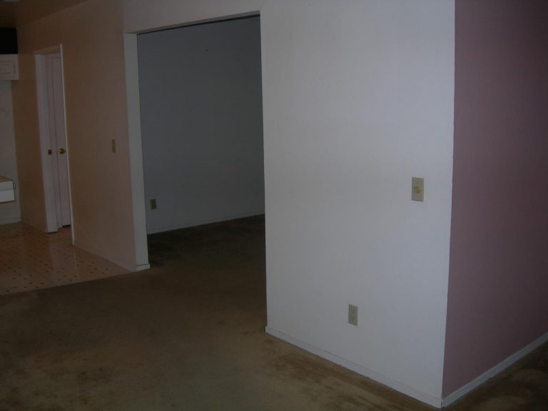A room with a white wall and a pink wall.