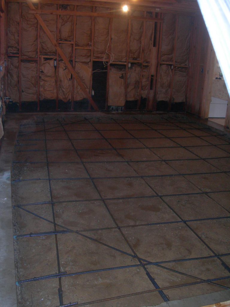 A room that is being remodeled with a concrete floor.
