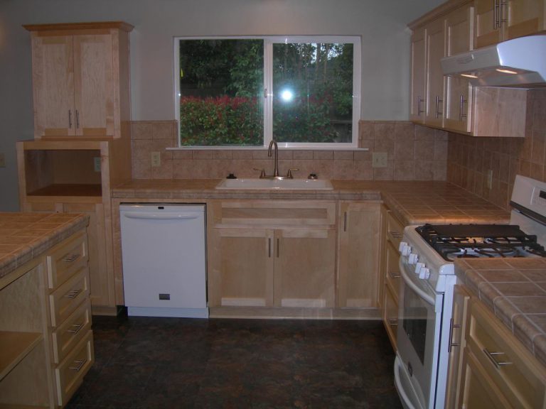 A kitchen with a stove and sink.