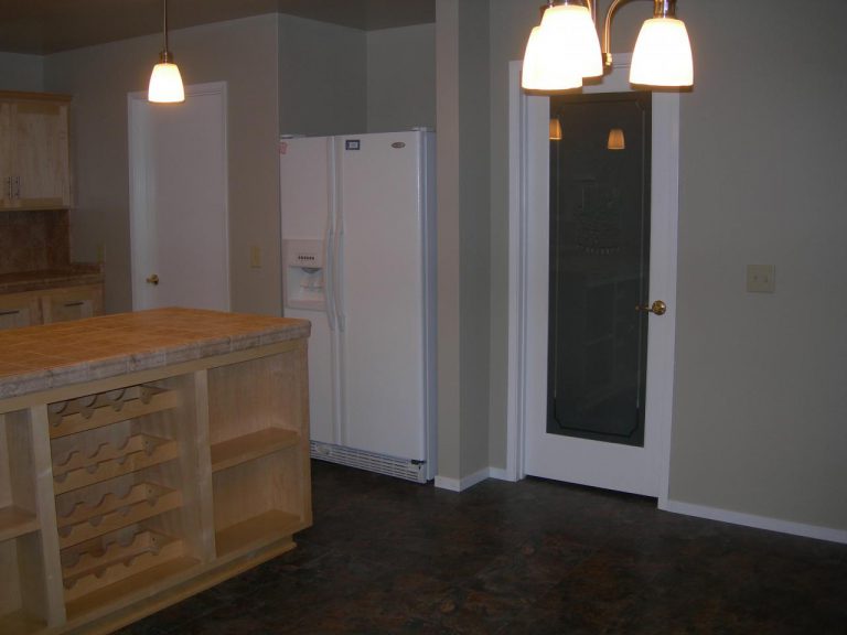 A refrigerator in a kitchen.