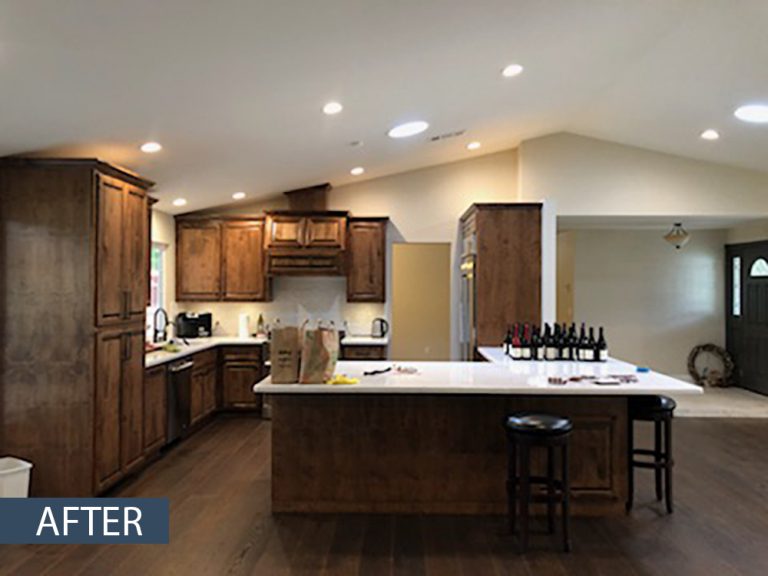 A kitchen that has been remodeled with wood cabinets.