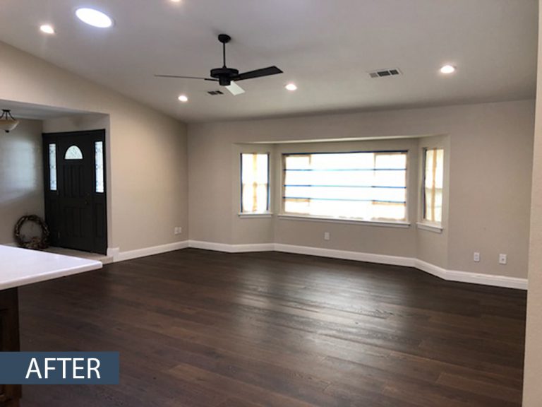 A living room with hardwood floors and a ceiling fan.