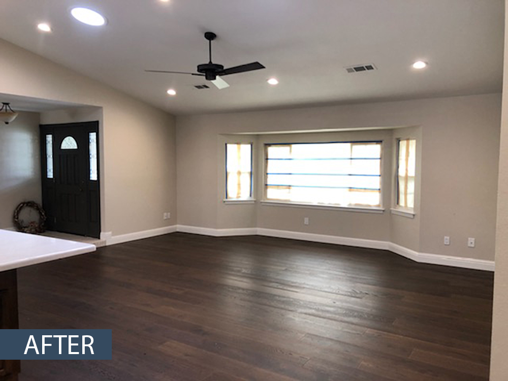 A living room with hardwood floors and a ceiling fan.