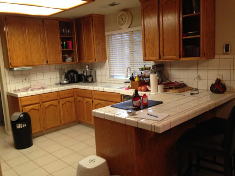 A kitchen with wooden cabinets.