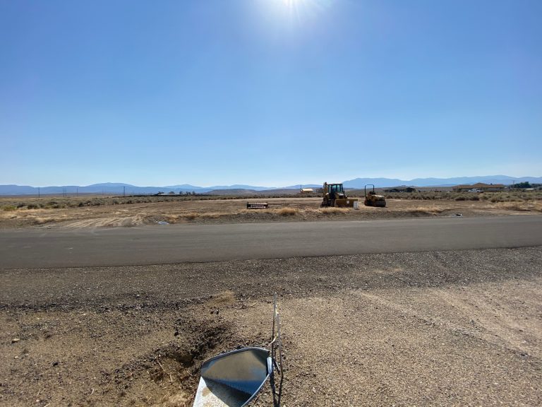 A construction site with a boat in the middle of the road.
