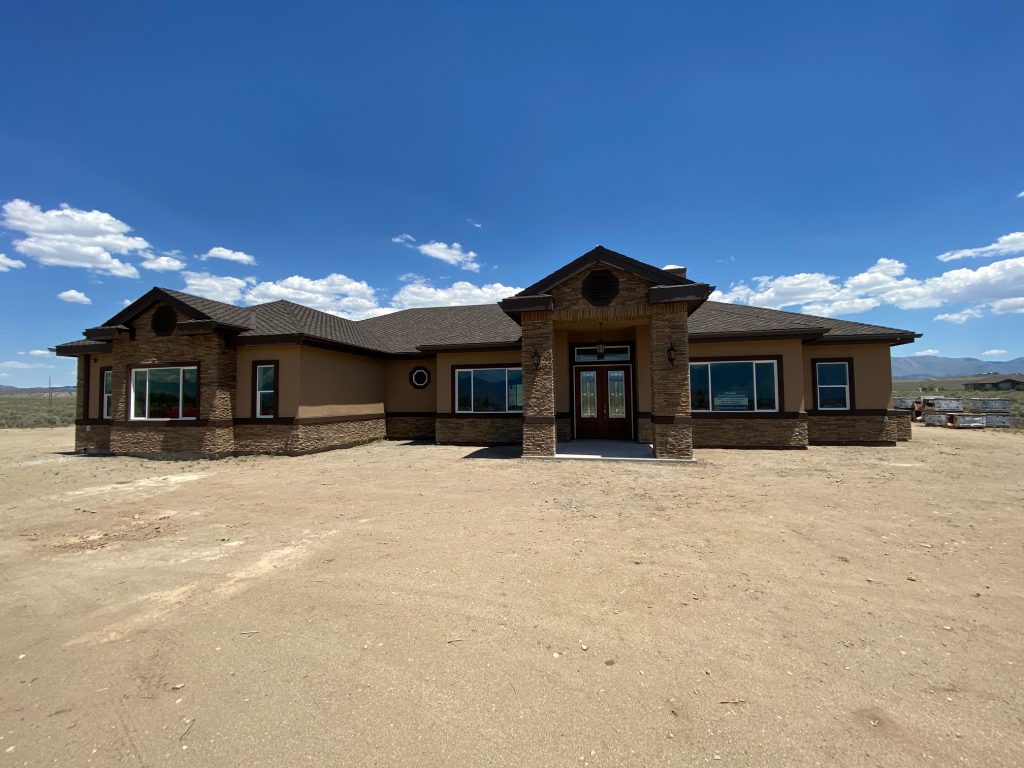 A house in the middle of a desert.